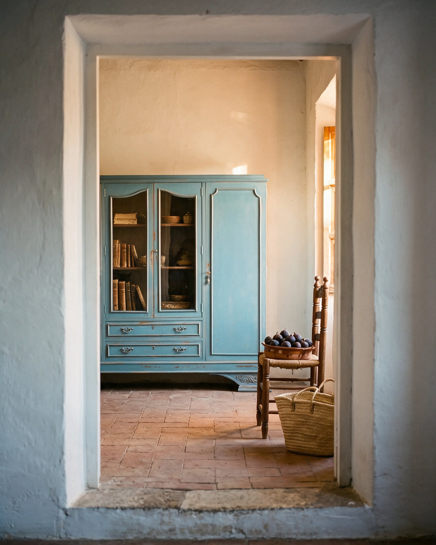 Librería vitrina azul decapé en estancia de casa de campo con suelo de barro — Antique Arte y Decoración