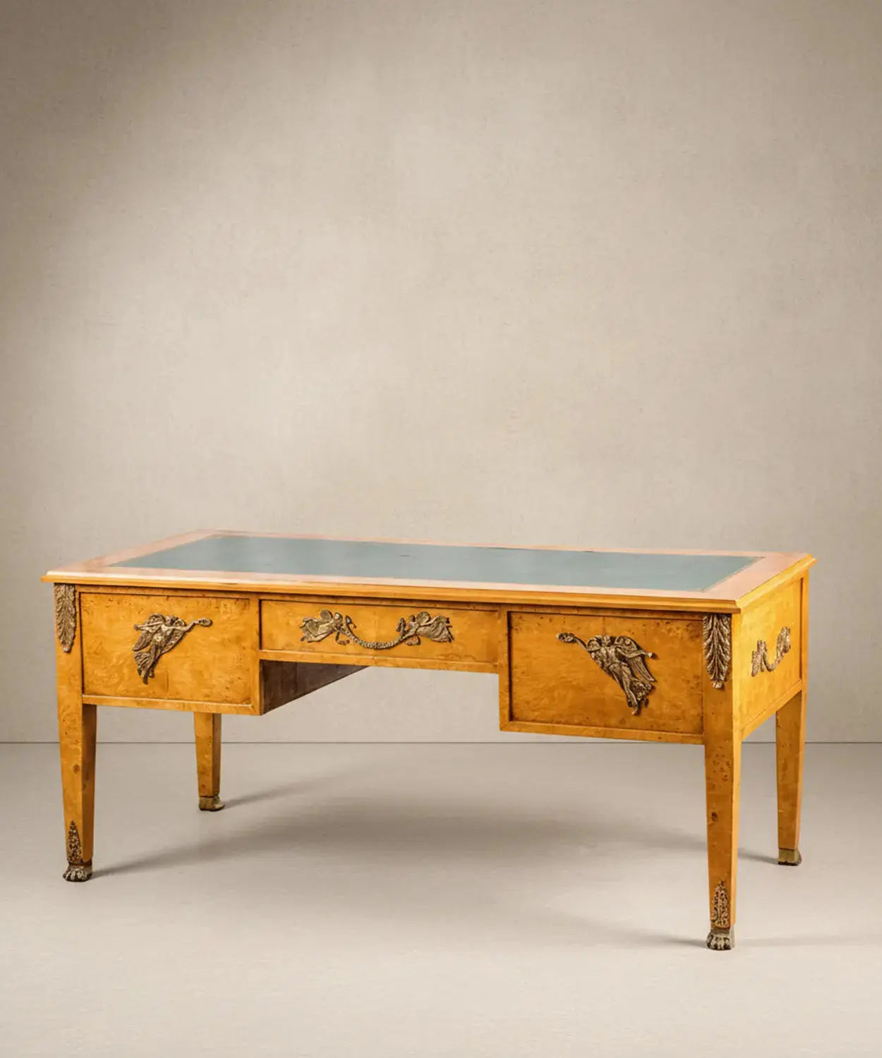 Vista angular del escritorio resaltando el veteado de la madera de raíz y los sabots de garra de león.