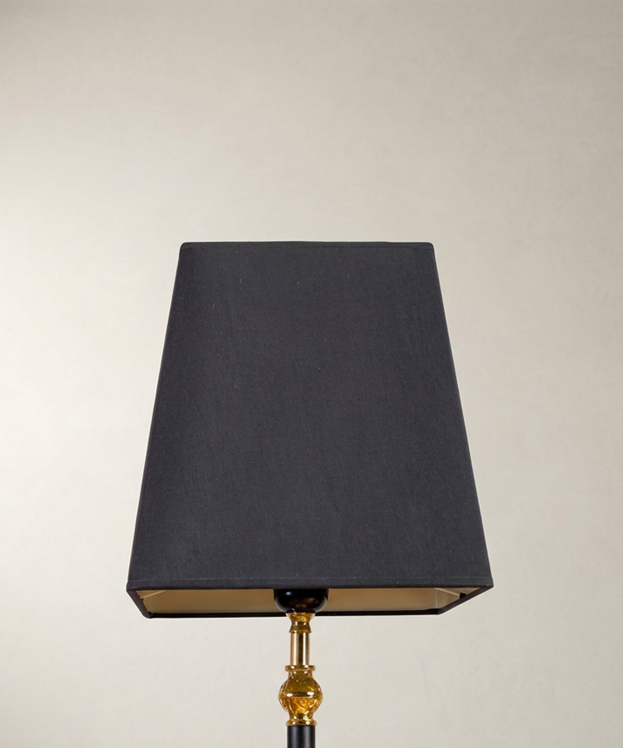 Textura del tejido de la pantalla negra y remate superior dorado.