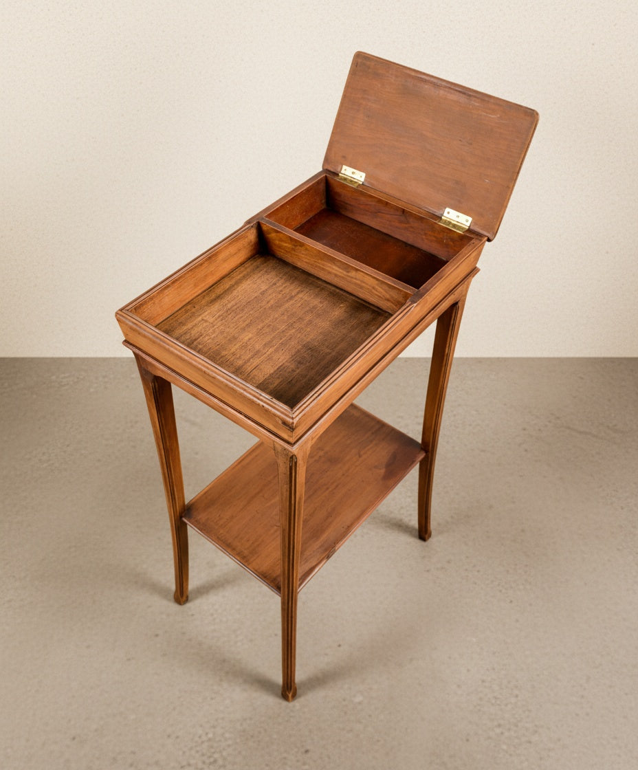 Mesa francesa con tapa abatible abierta mostrando el compartimento interior de almacenamiento.