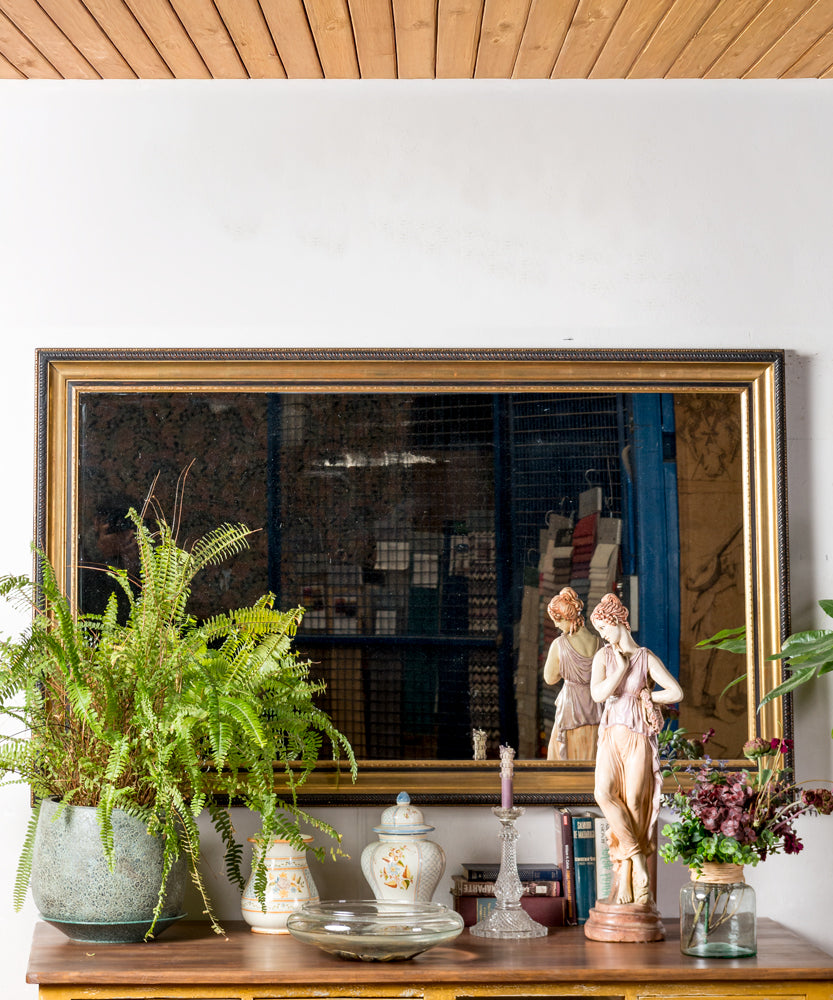 Antique mirror with black and gold frame