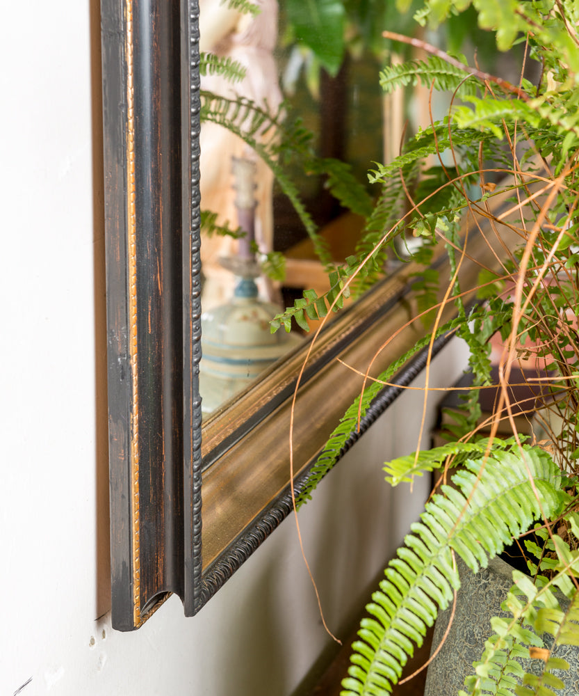 Antique mirror with black and gold frame