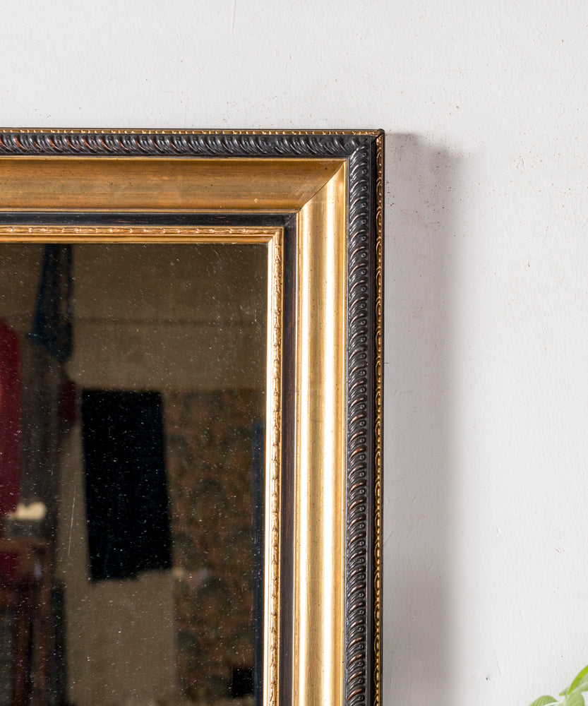 Antique mirror with black and gold frame