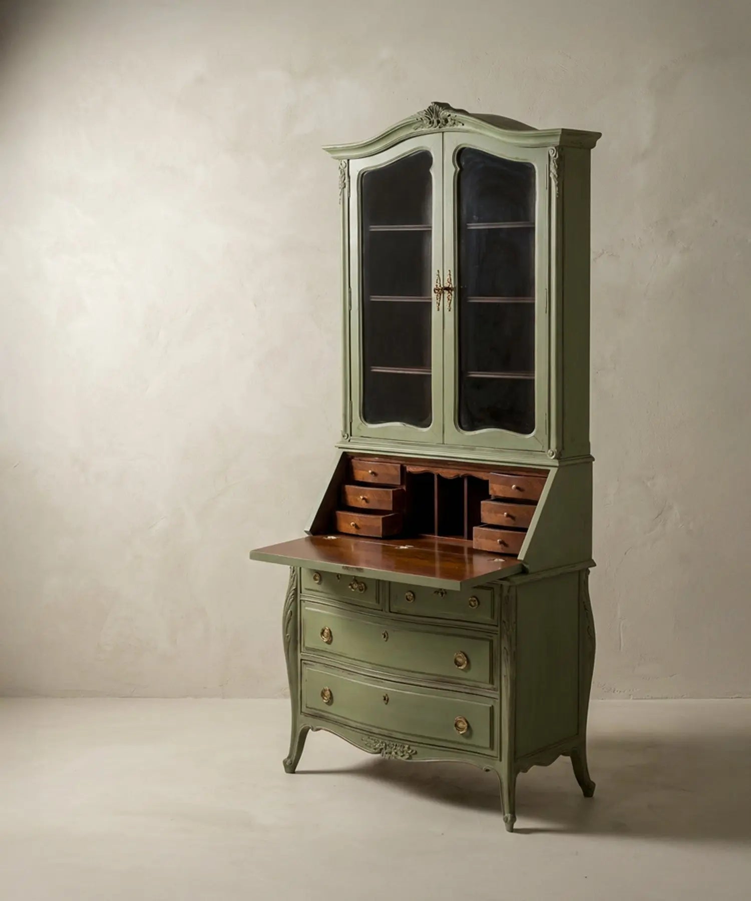 Detalle del tablero abatible y pequeños cajones interiores de madera noble en contraste con el exterior verde