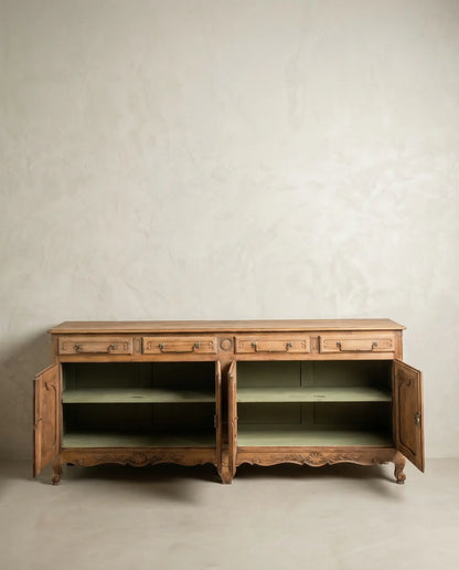 Aparador antiguo de madera con puertas abiertas mostrando interior pintado en verde salvia.