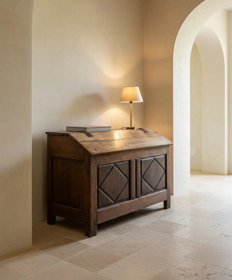 Vista frontal en ángulo de arca  antigua de madera con tapa inclinada y tallas de rombos.