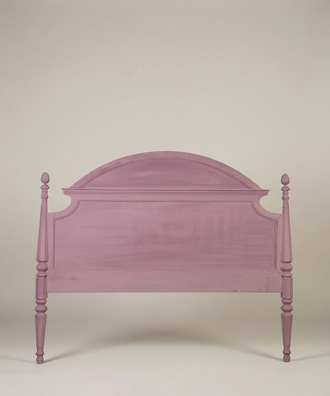 Vista frontal del cabecero de cama estilo gustaviano en color rosa empolvado sobre fondo neutro