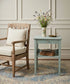 Mesa auxiliar azul cielo decapé en salón con sillón Windsor cepillado paredes con boiseries blancas y alfombra persa apagada estilo French country — Antique Arte y Decoración