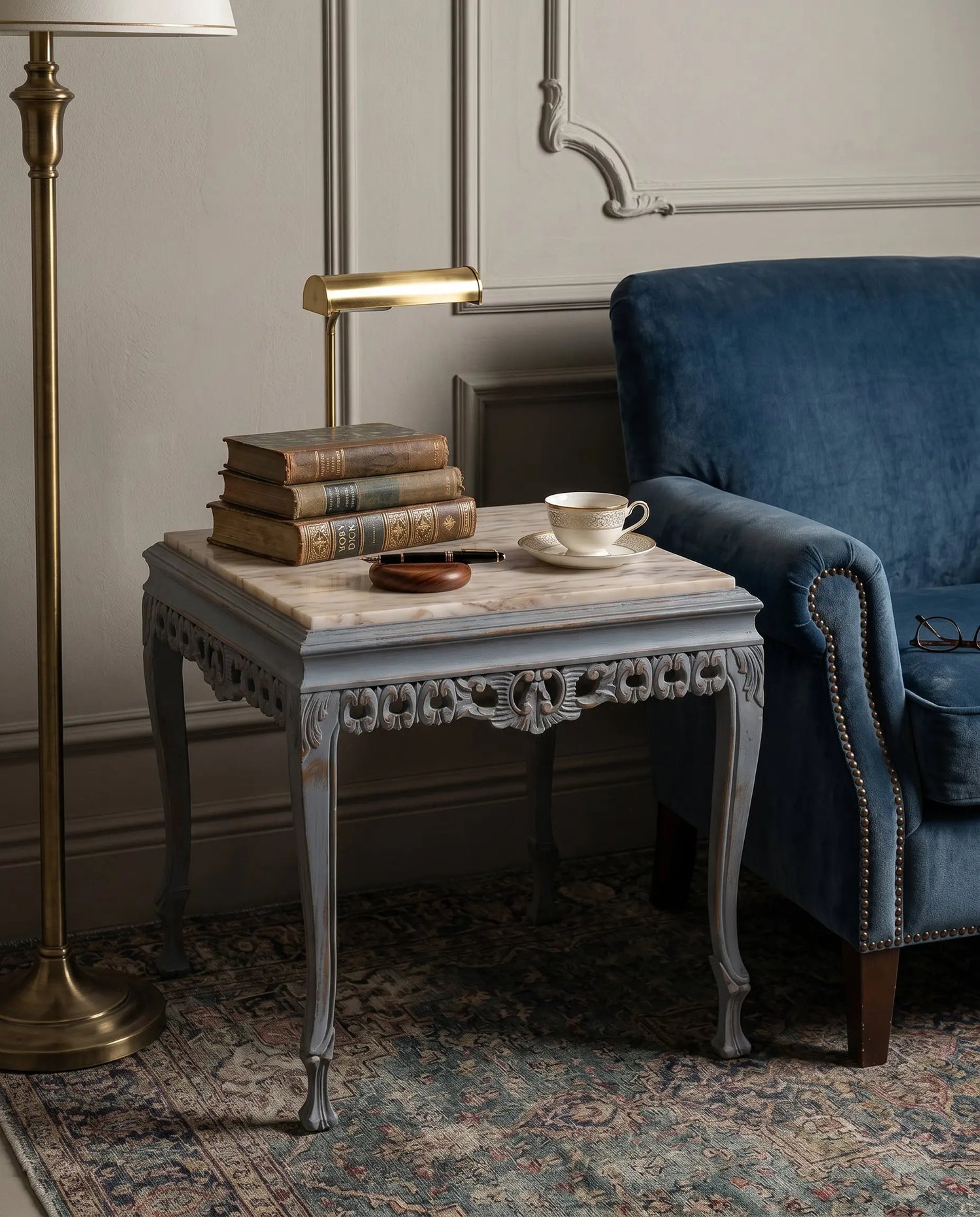 Mesa auxiliar estilo Luis XV con sobre de mármol en salón clásico junto a sillón azul — Antique Arte y Decoración