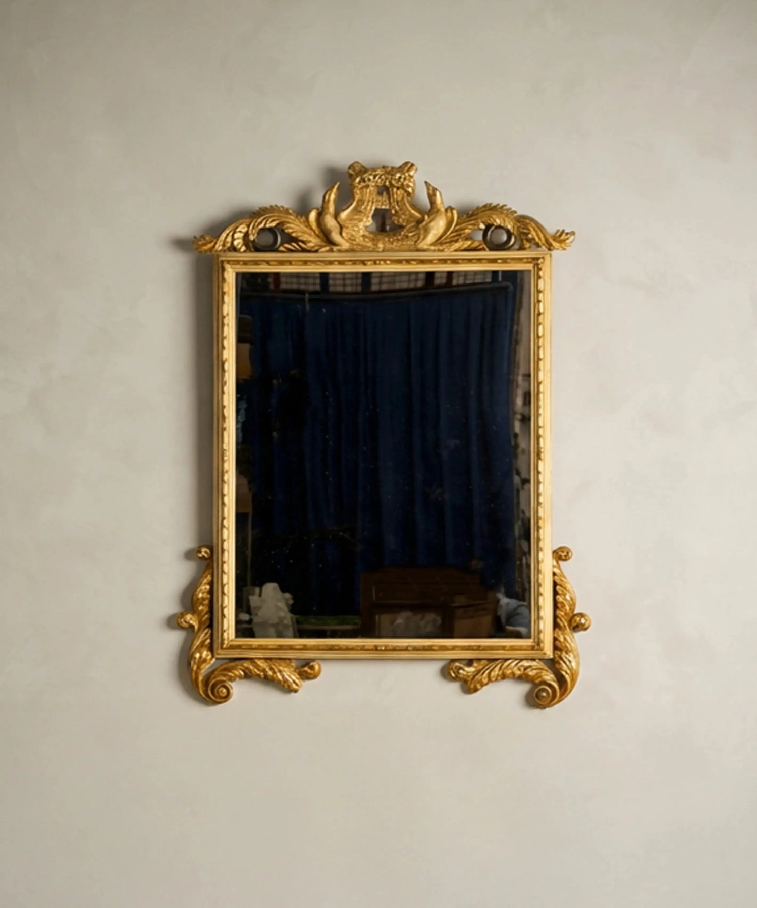 Espejo de pared vintage de gran formato con marco dorado y copete tallado con cisnes.