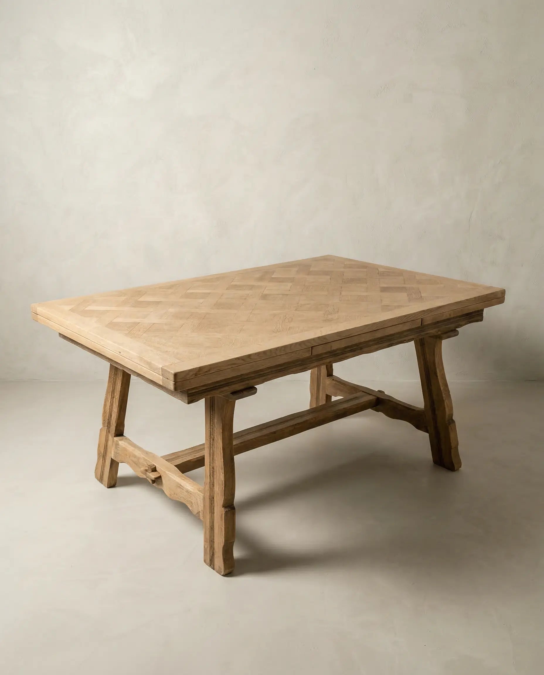  Estructura inferior de mesa de comedor con tallas artesanales y sistema de extensión visto.