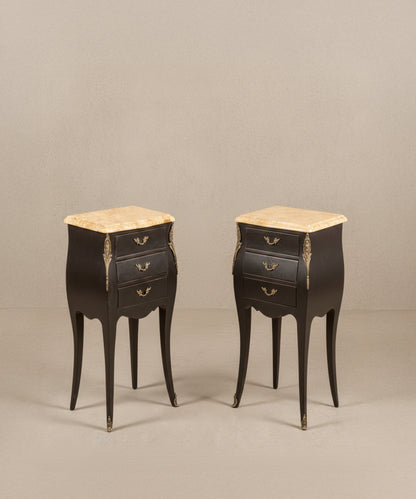 Pareja de mesillas de noche francesas estilo Luis XV en color negro mate con tres cajones y sobres de mármol.