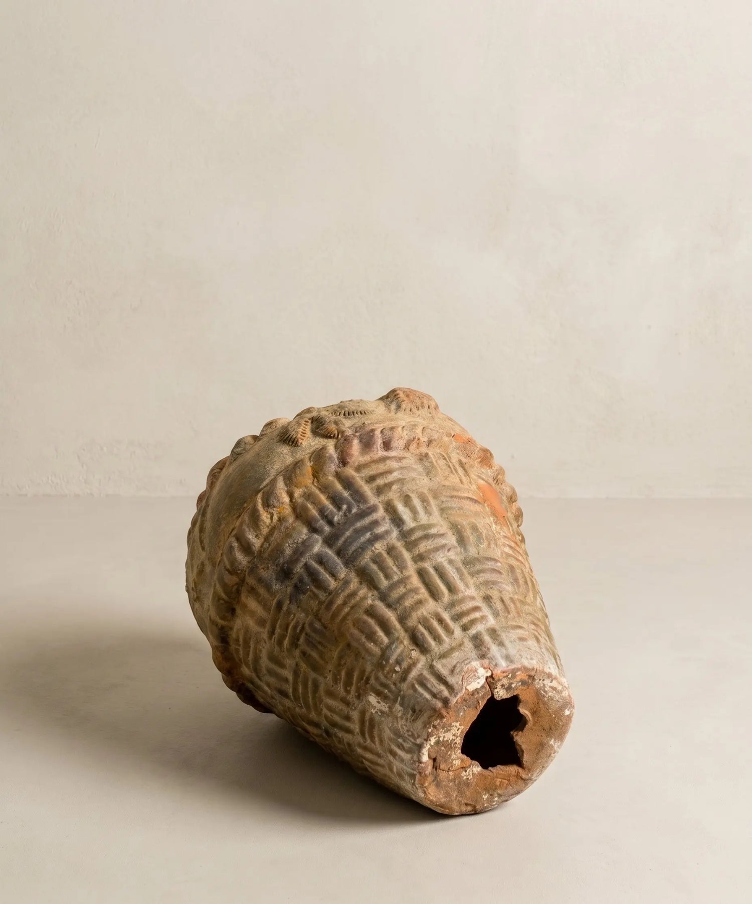 Macetero antiguo de terracota con relieve de cestería y motivos florales