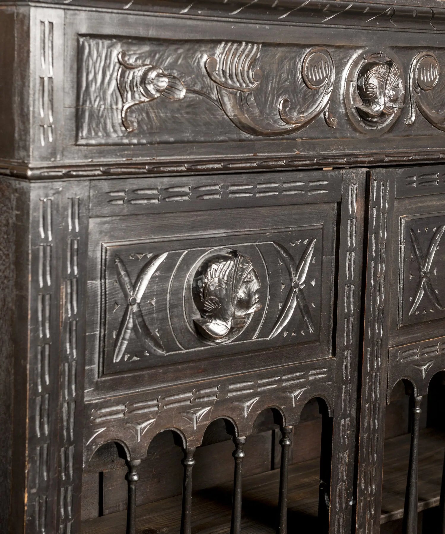 Detalle del panel superior con medallón figurativo de cabeza tallada y motivos circulares — Antique Arte y Decoración
